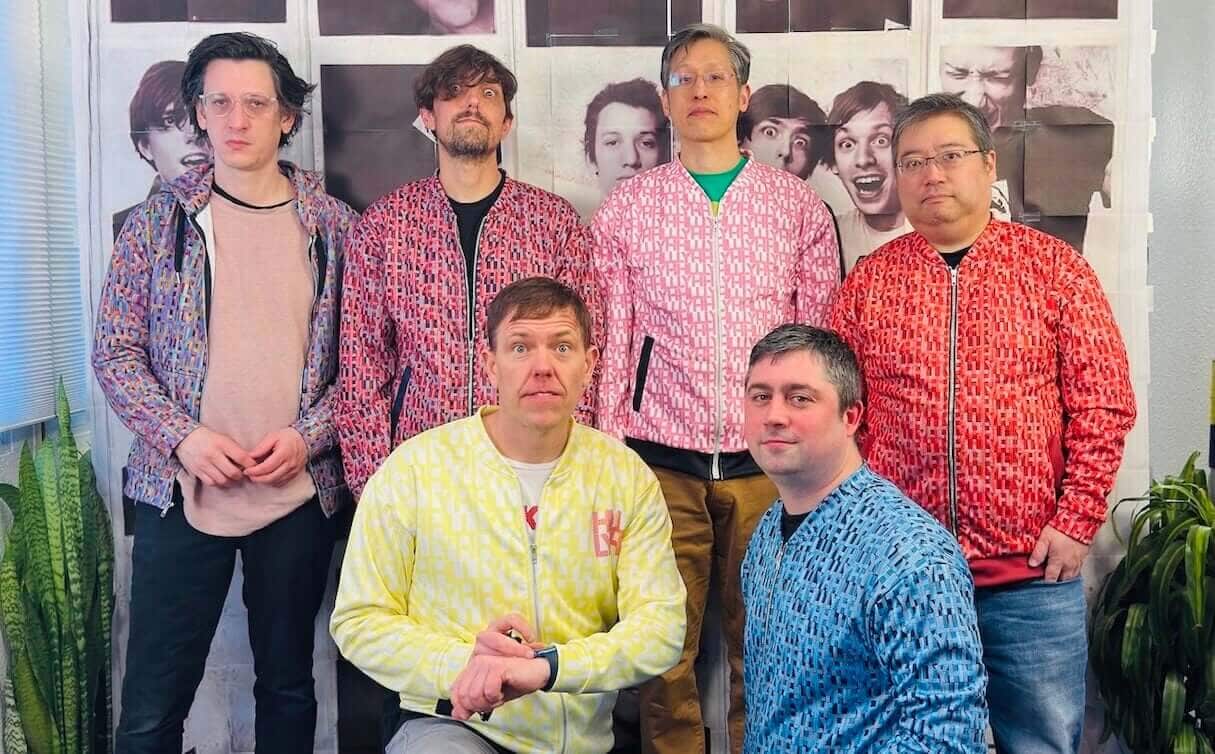 The members of HLLLYH are (back row) Ezra Buchla, Jeff Byron, Dan Chao, and Burt Hashiguchi, (front row) Tim Byron and James Baker.