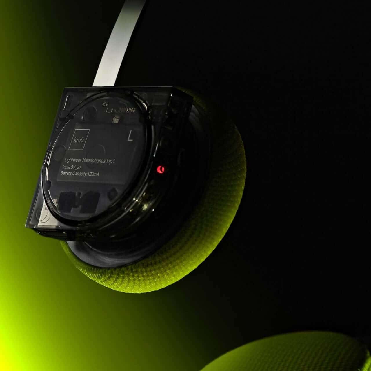 Close-up view of neon yellow CD player’s illuminated circuit board and wiring