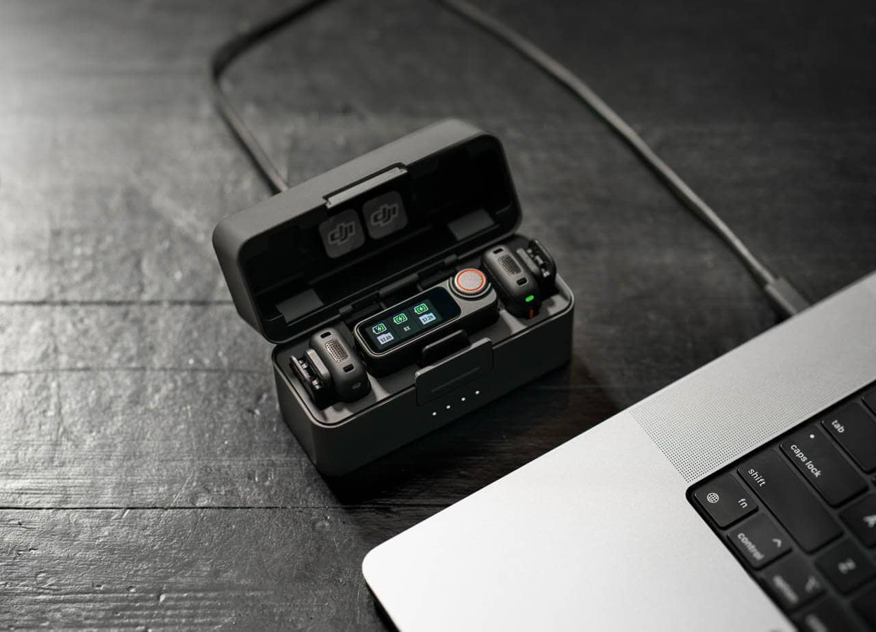 Charging case connected to computer, showing DJI Mic 3’s seamless workflow