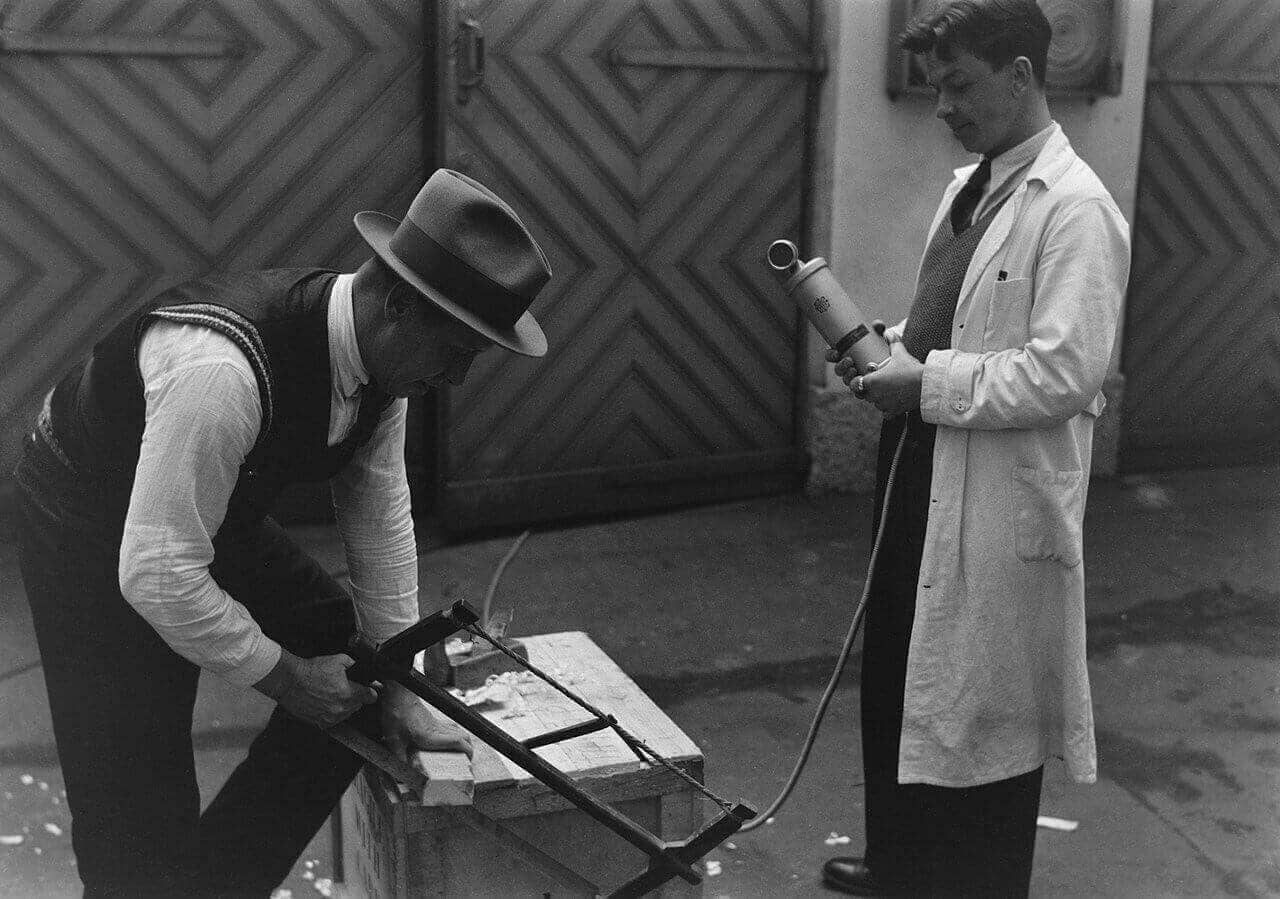 A man recording the sound of a saw in the 1930s