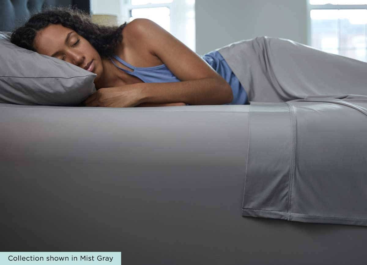 Woman Sleeping Comfortably in SHEEX bed sheets that regulate her body temperature