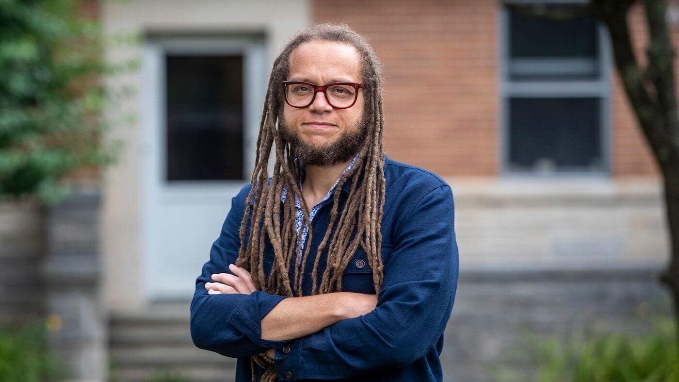 Professor Iain Pollock standing in front of house
