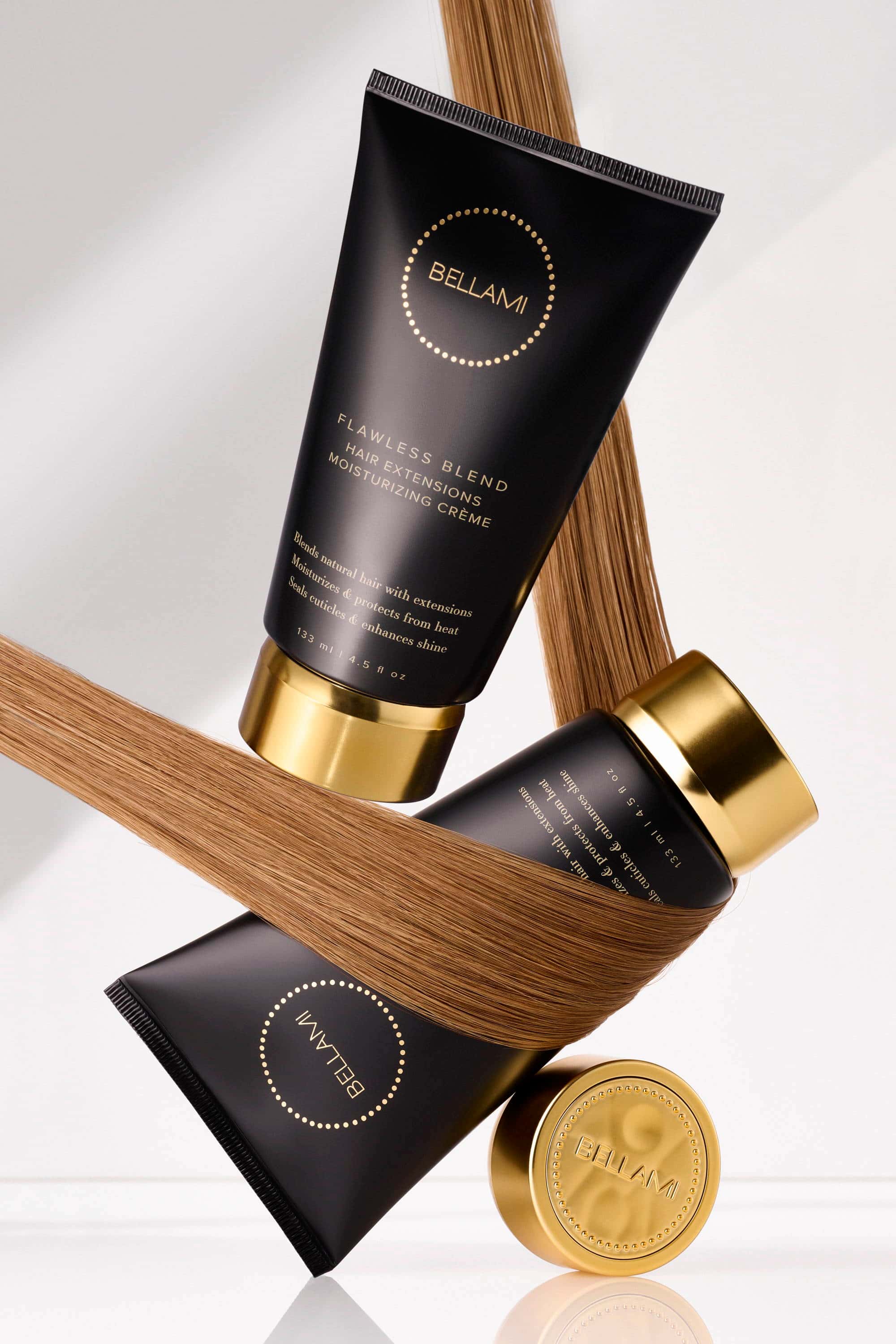 Bellami Flawless Blend Moisturizing Crème and hair care products with a strand of light brown hair wrapped around them.