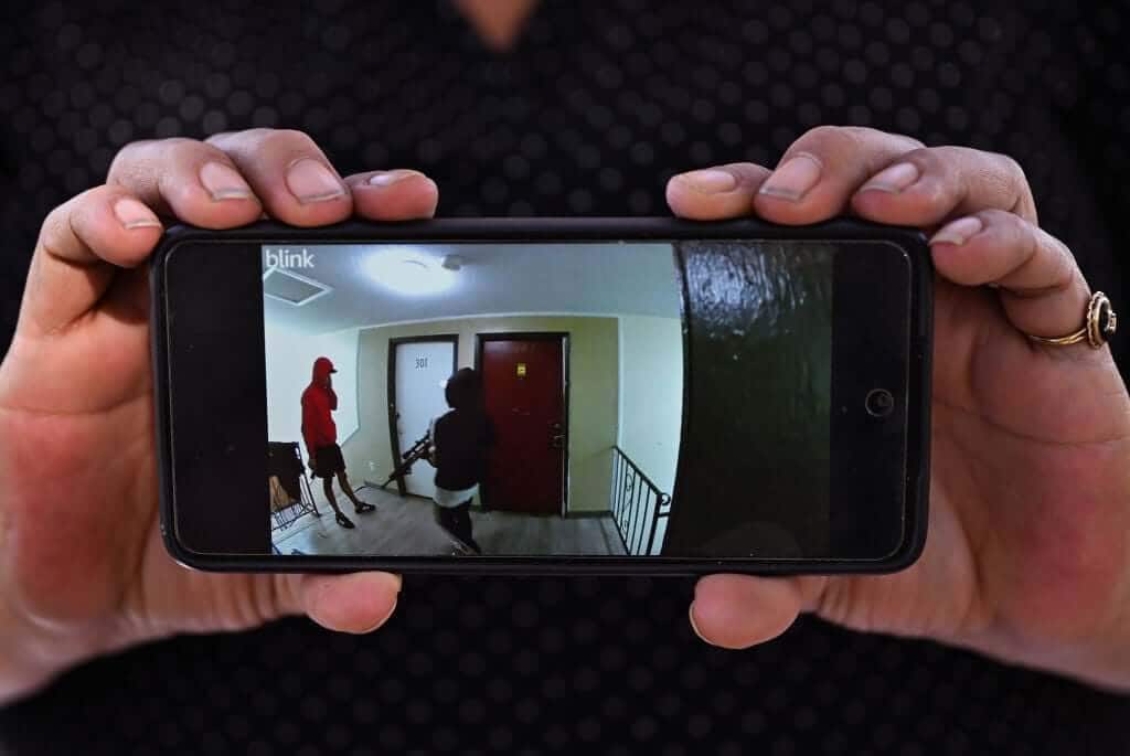 Cindy Romero holds viral surveillance video allegedly showing armed Tren de Aragua members in Aurora, Colorado