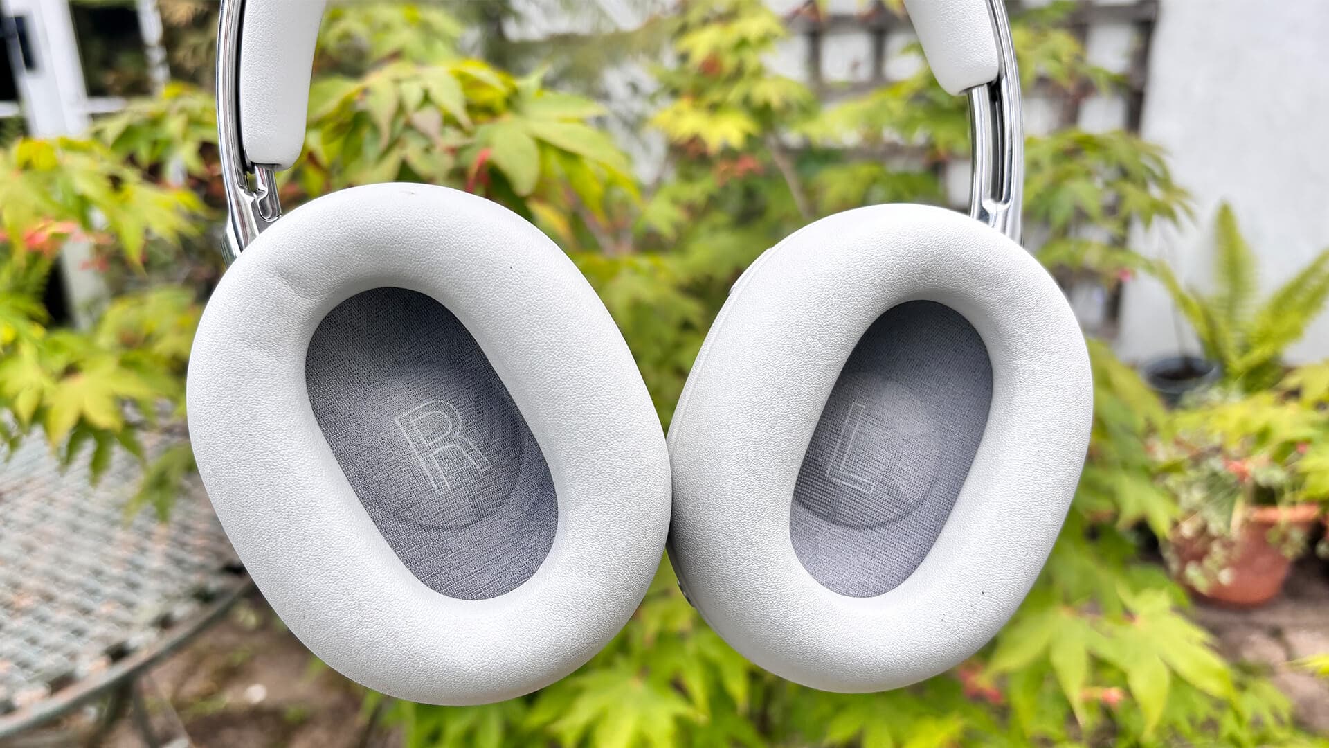 Sony 1000X The Collexion wireless headphones in front of garden plant with inner view