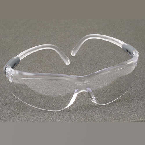 Clear safety glasses on a gray background.