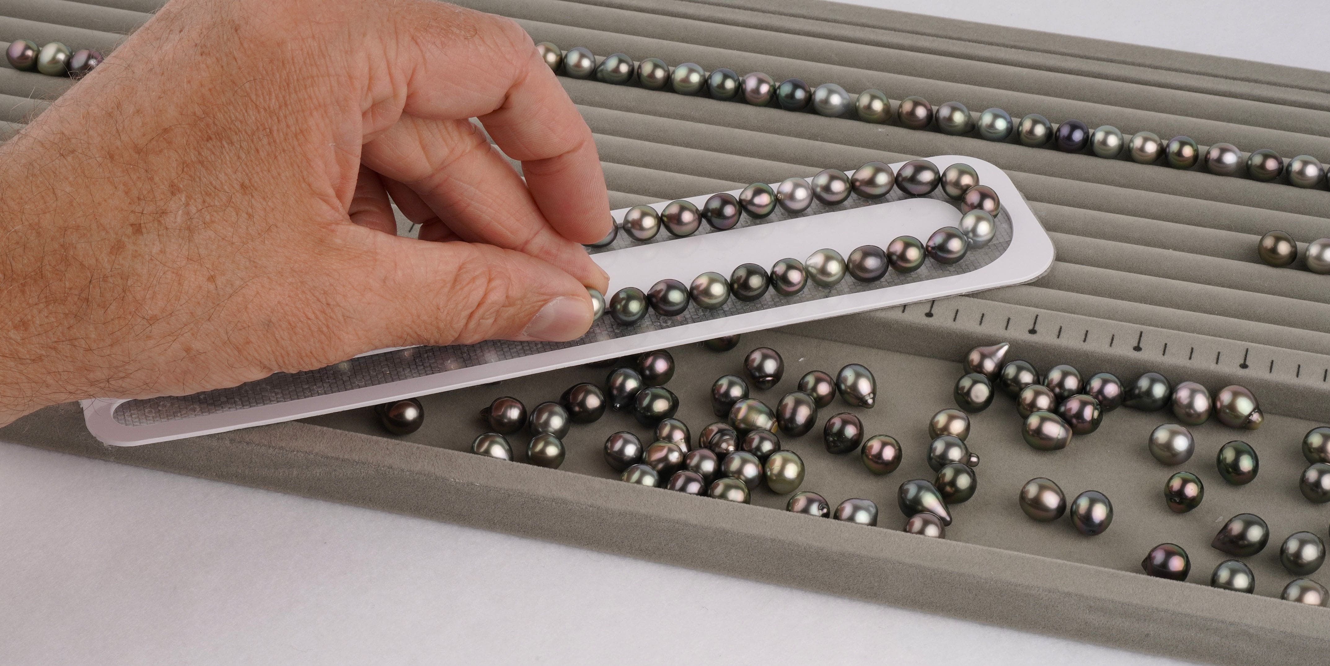 This is what we call the mockup stage, setting each Tahitian pearl on a sticky board.