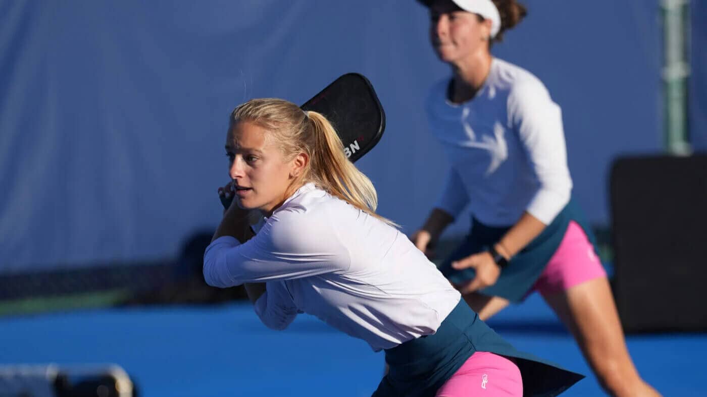 Two women playing in a pickleball doubles match