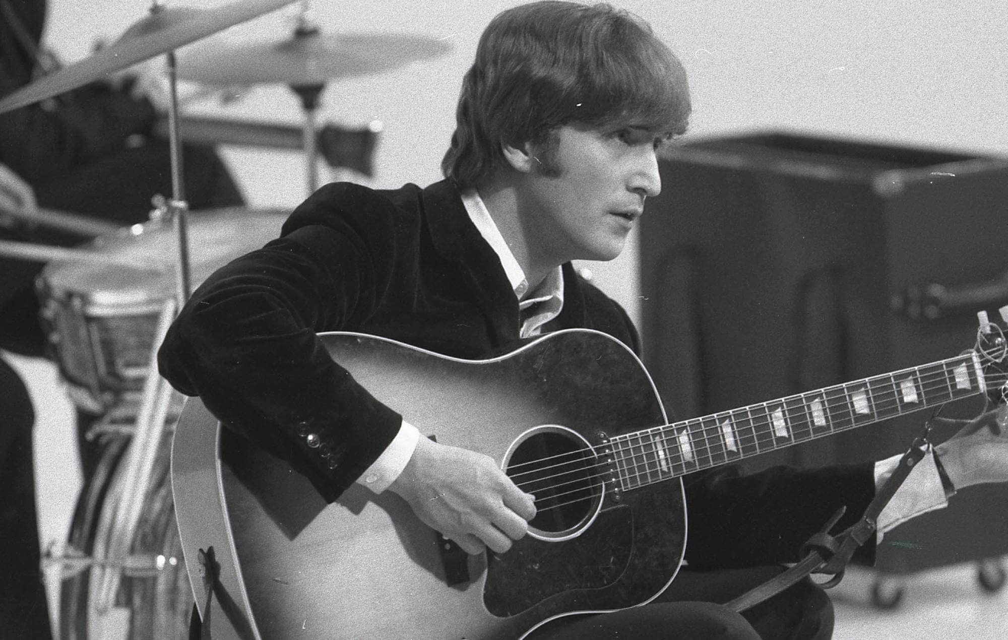 John Lennon in his element, the creative genius behind timeless Beatles tunes.