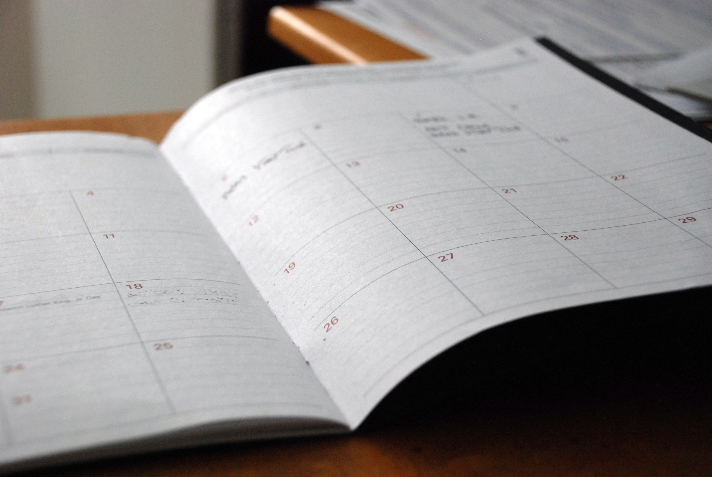 Open monthly planner on a wooden desk