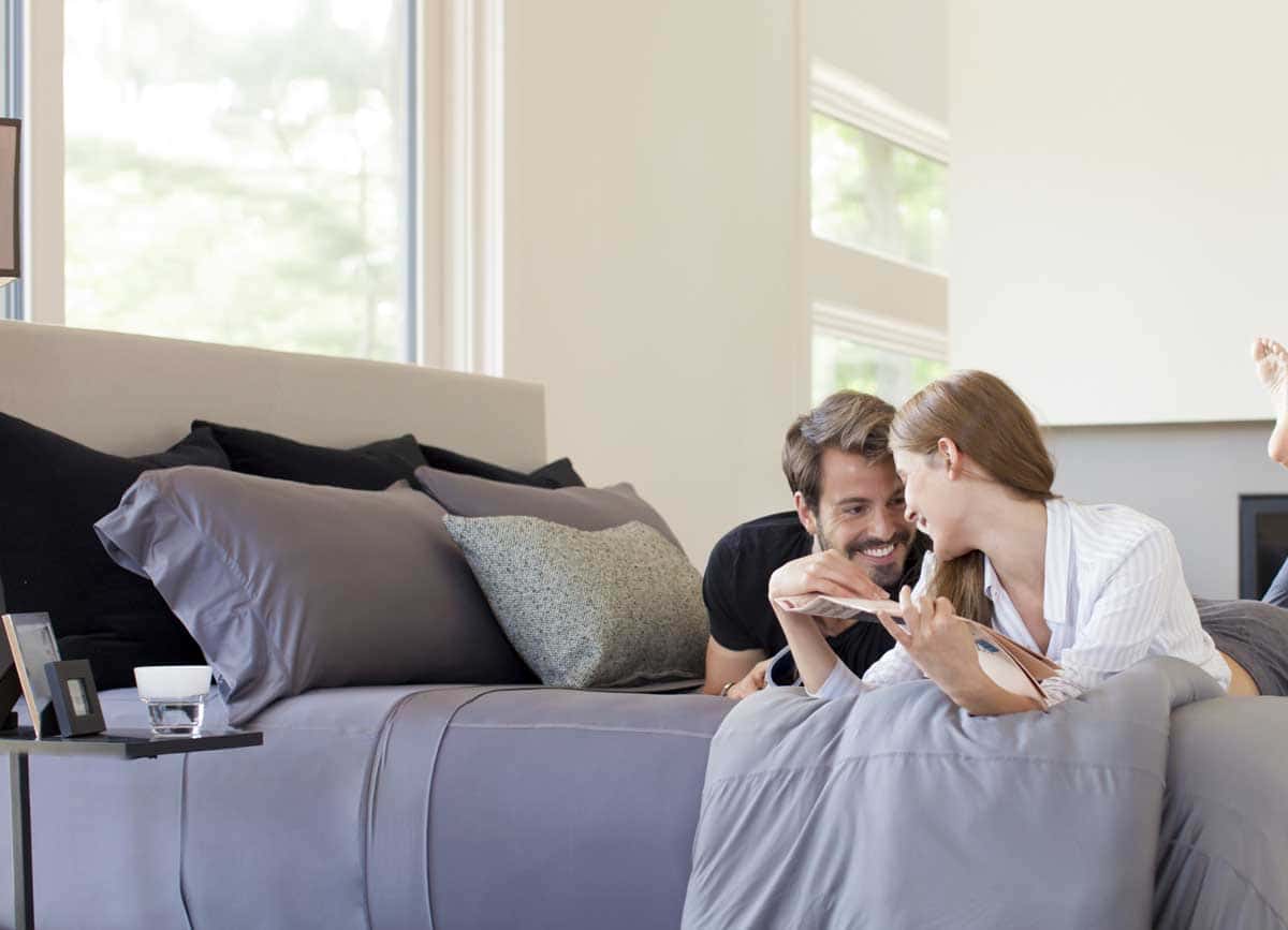 Couple Cuddled in their Temperature Regulating Bedding Sheets