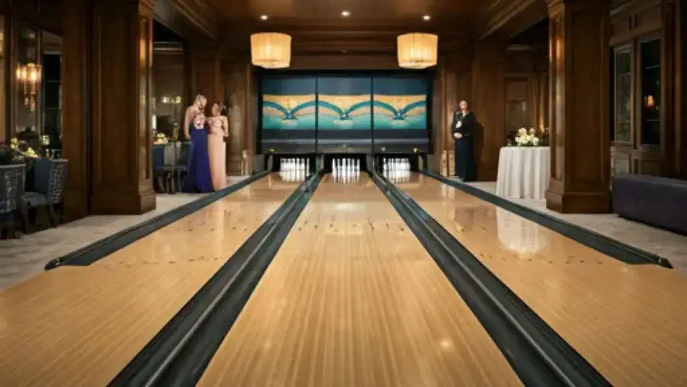 A luxurious, carpeted bowling alley, complete with sleek wooden lanes, is a centerpiece of a lavish home hosting a lively party. Guests in elegant attire are enjoying the evening, bowling and laughing.