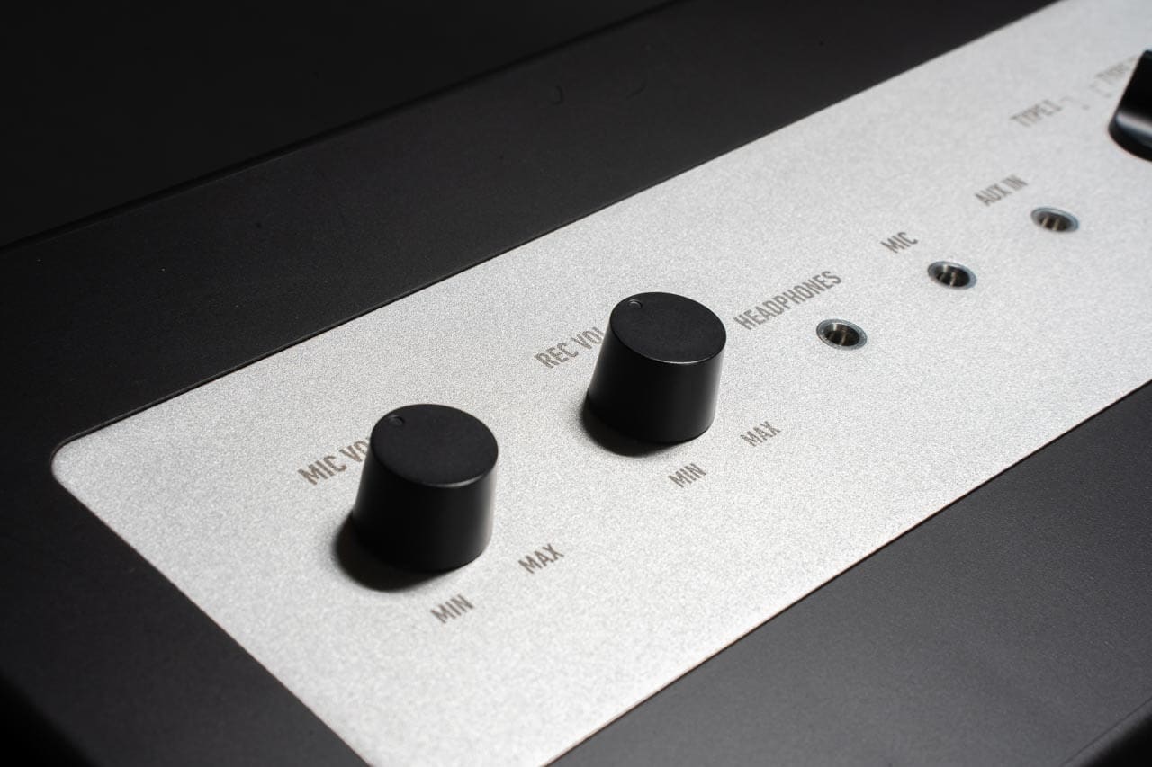 User adjusting mic volume controls