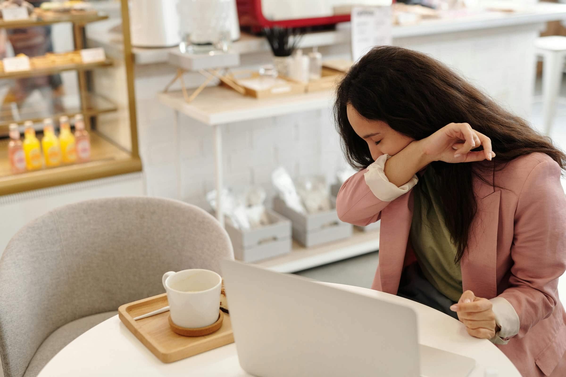 sick woman covering her mouth.