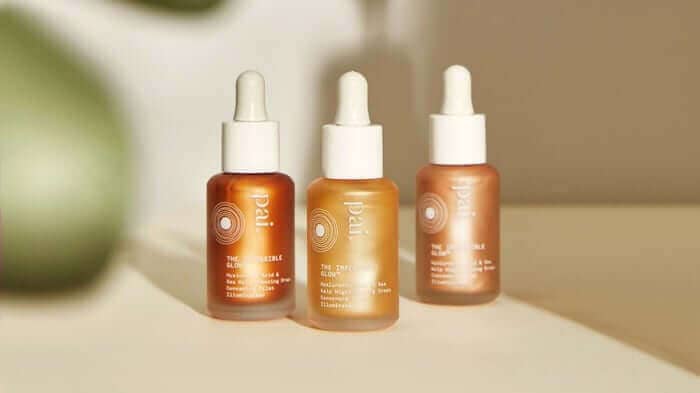 Three Pai Skincare glow drops bottles in amber glass with white droppers, featuring different formulations for sensitive skin in warm natural lighting