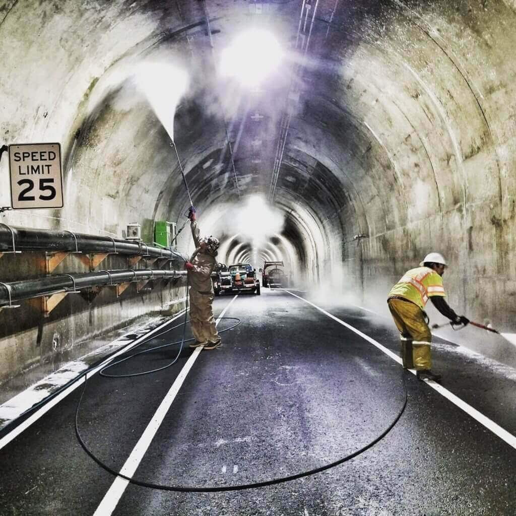 Carlos Gonzalez walking through an industrial tunnel at a commercial cleaning job
