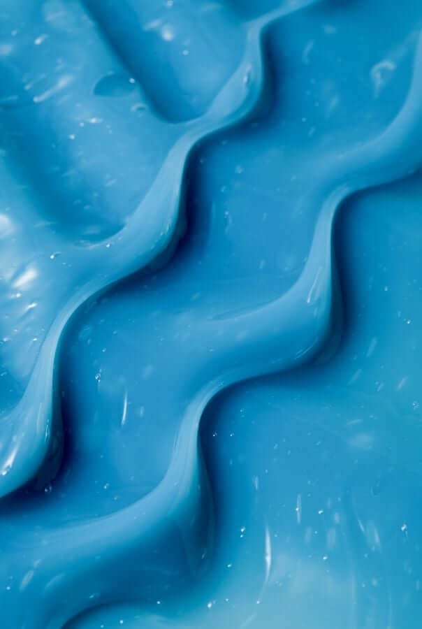 Close-up texture of bright blue Resurrection Girl hydrating face mask showing smooth, creamy consistency