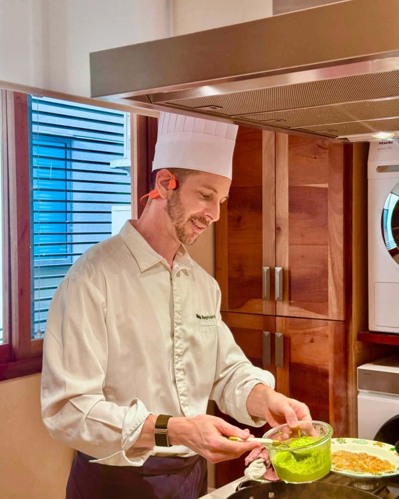 Close-up of StudioChef KAI headphones resting on chef’s cheekbones