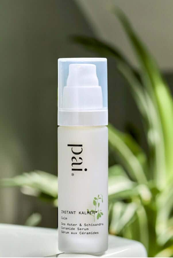 Pai Instant Kalmer ceramide serum with white pump dispenser against green foliage background