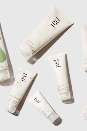 Pai Skincare organic certified tubes arranged in elegant flatlay showing sustainable packaging