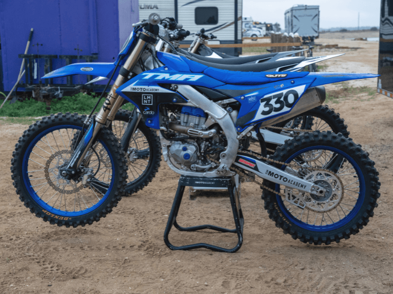 The Moto Academy rental bike fleet — Stark Varg Electric, Kawasaki KX250, Yamaha YZ450, Kawasaki KX450 Race-Ready, and Honda CRF110 available at every 5-Day Camp