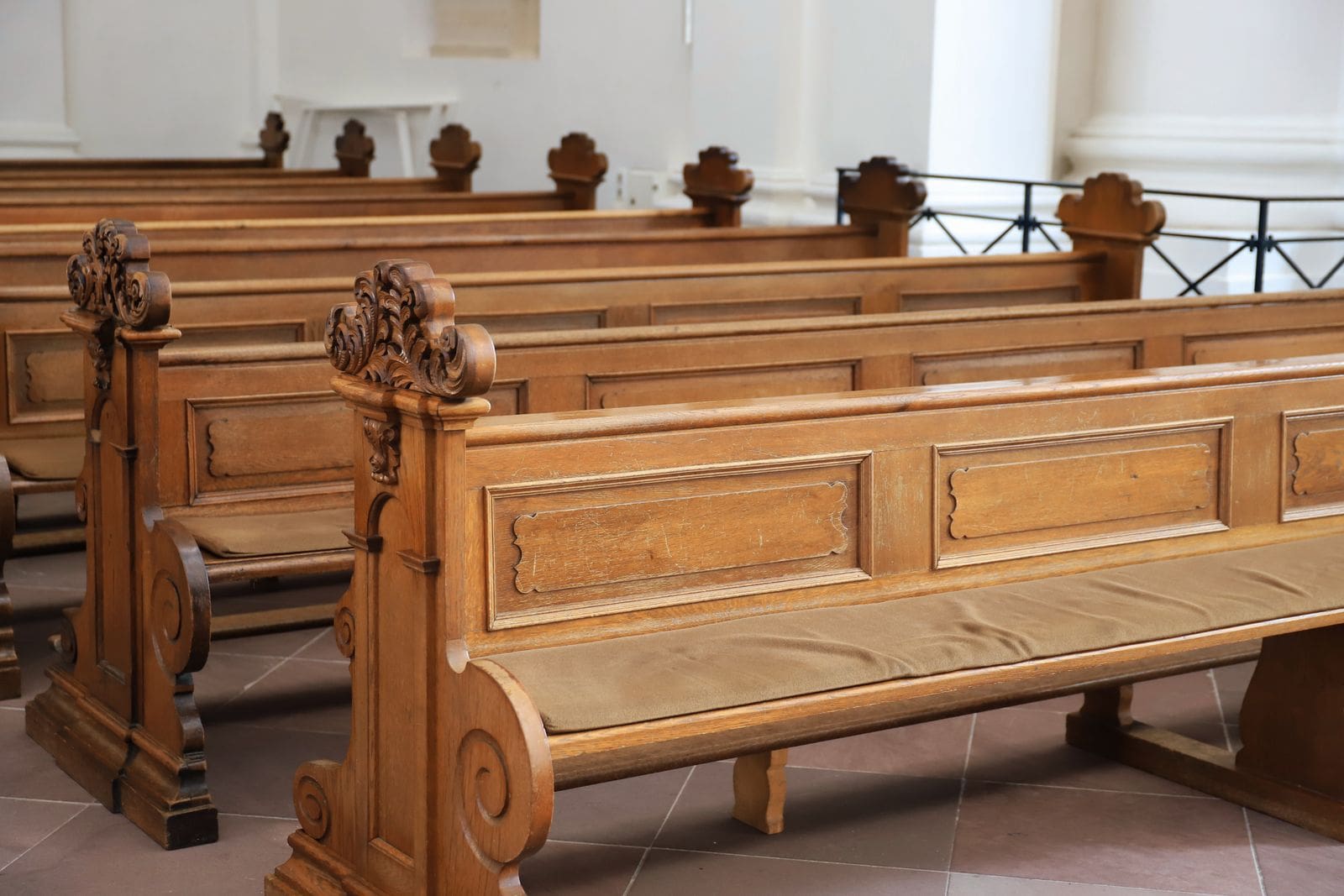 Rows of polished wooden courtroom seating representing the legislative and judicial processes shaping new body camera redaction laws