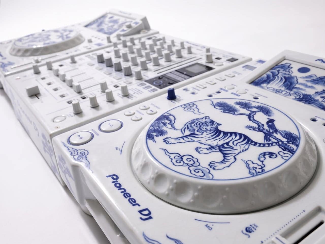 Porcelain-inspired DJ screens showing mountains, water, and moon imagery