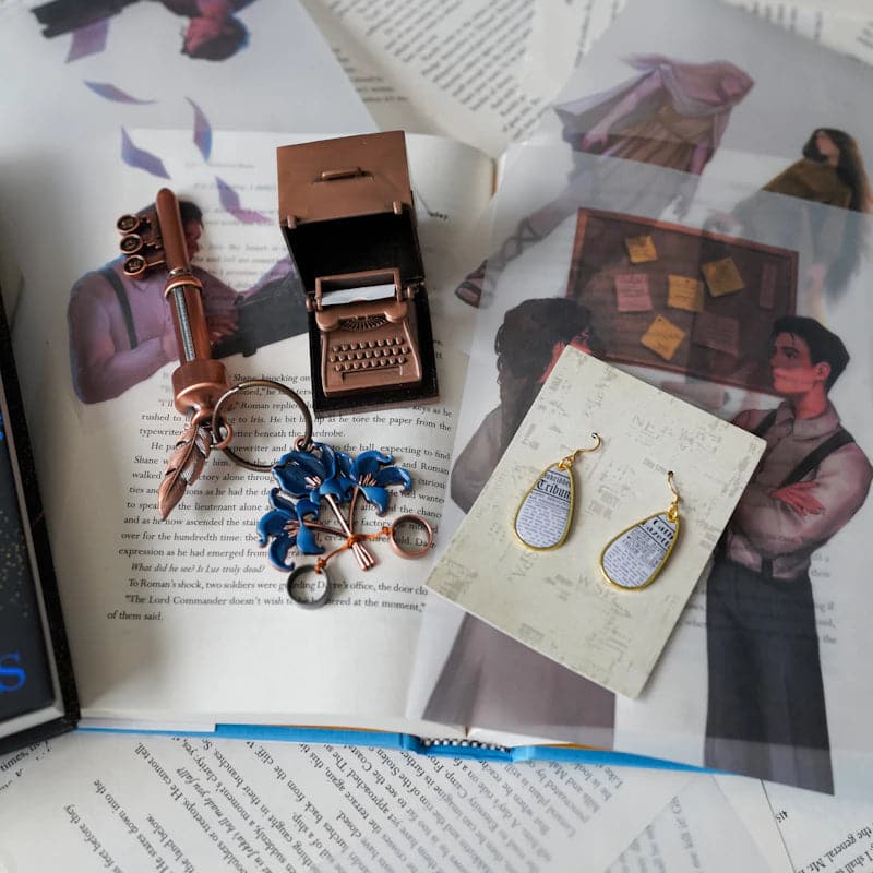 Divine Rivals collection with typewriter desk organizer, key, and newspaper earrings by LitJoy Crate