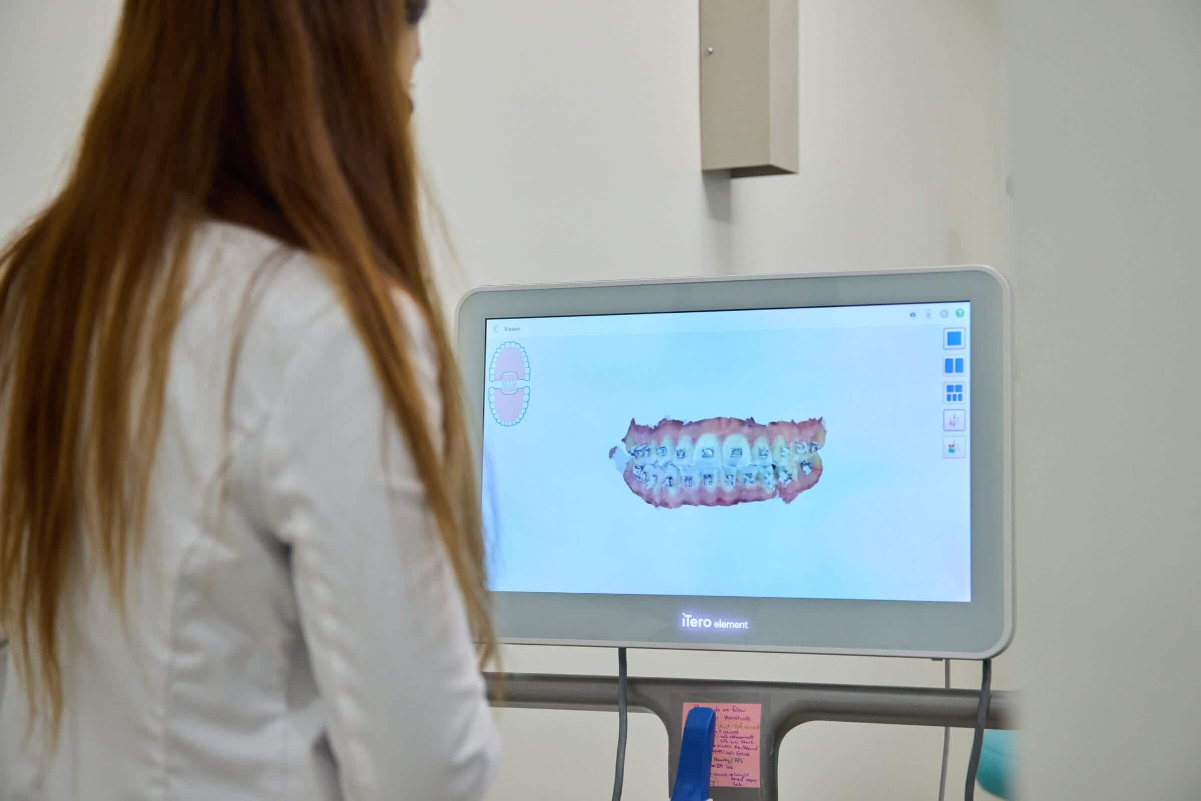 A woman looking on a monitor