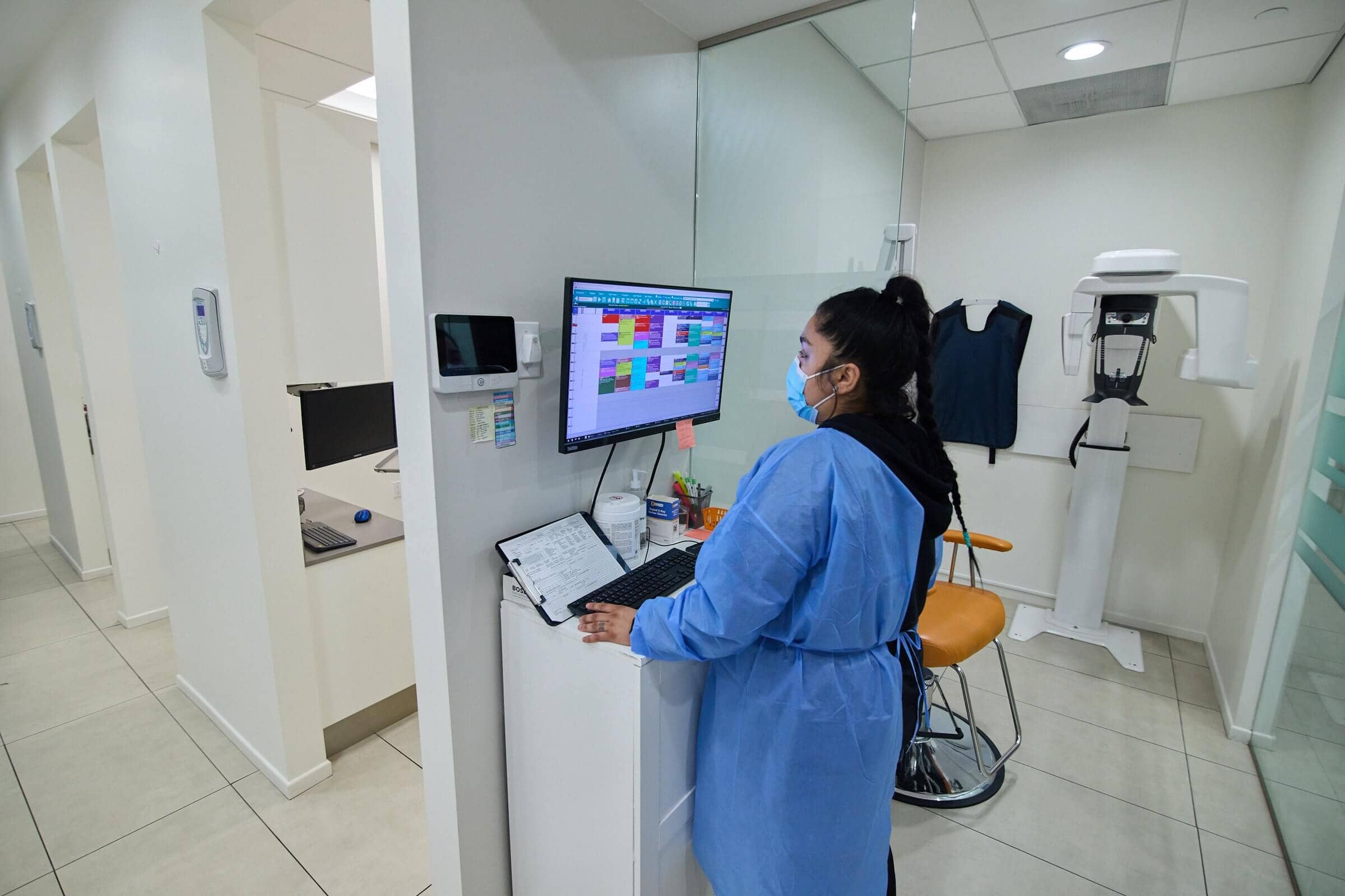 A woman looking at a screen wearing a blue robe