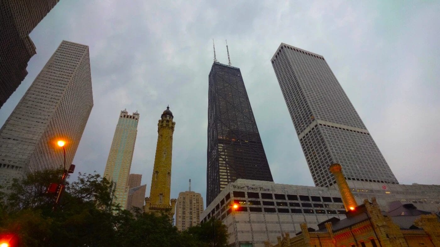 The Gothic Revival Chicago Water Tower with Chicago's modern Magnificent Mile skyline at night