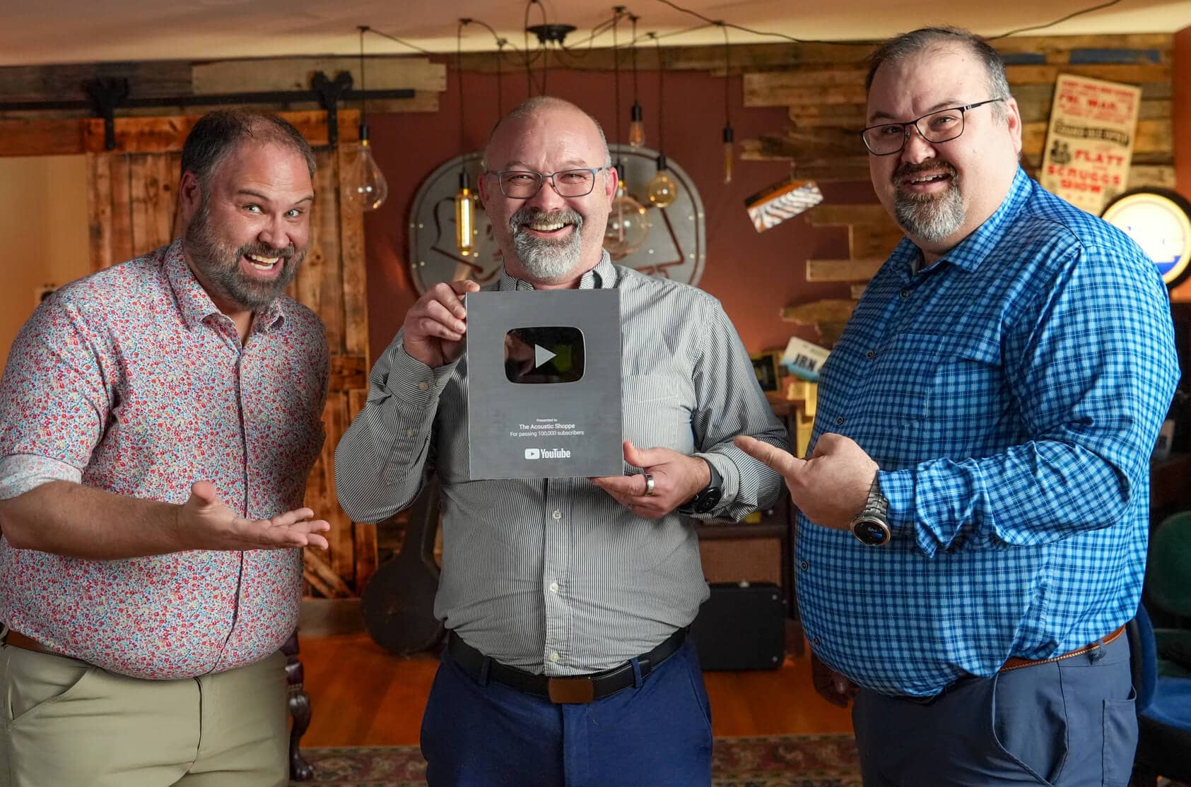 Jeremy John Jason Chapman celebrating their 100,000 subscriber milestone for the acoustic music community with the YouTube Silver Play Button.