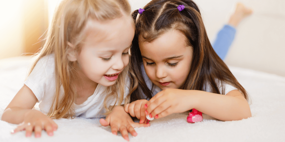 Two children painting their nails.