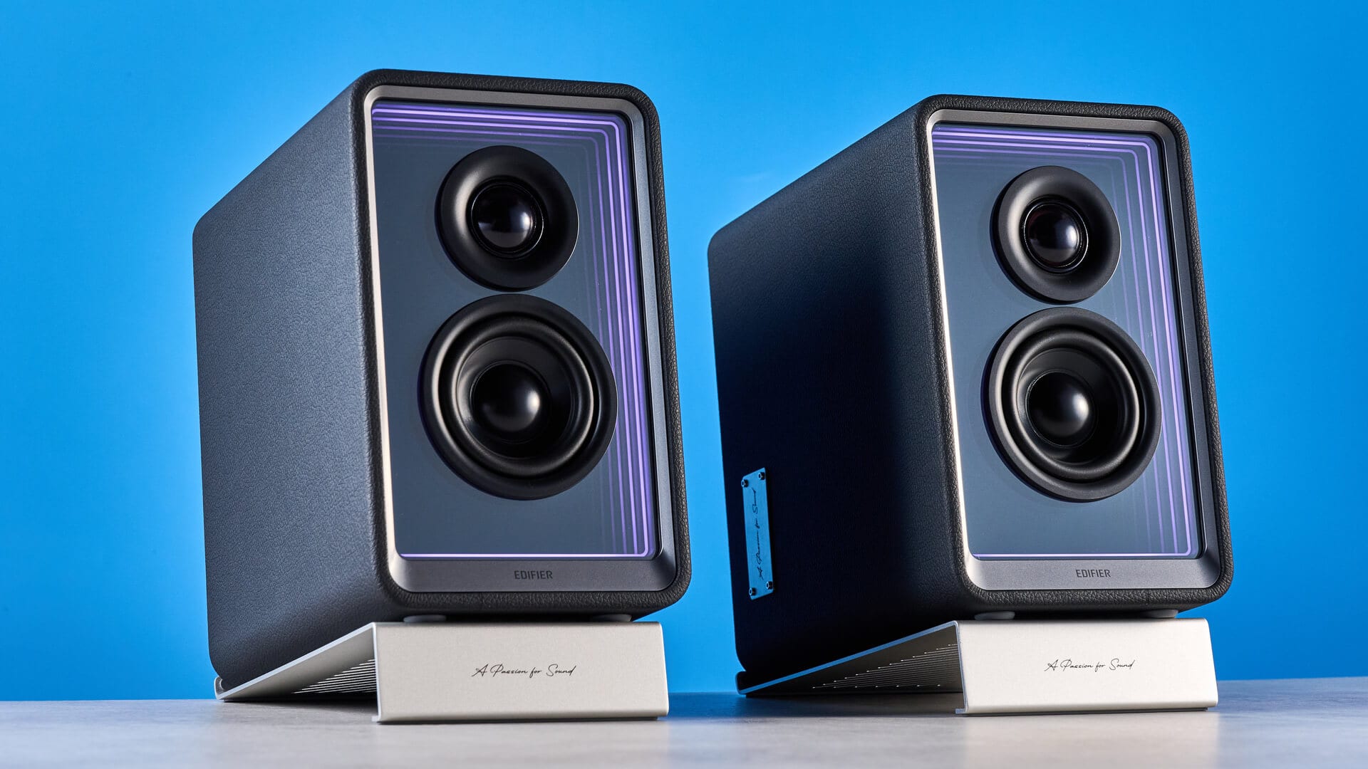 Close-up of Edifier QR65 speakers with glowing LED panels
