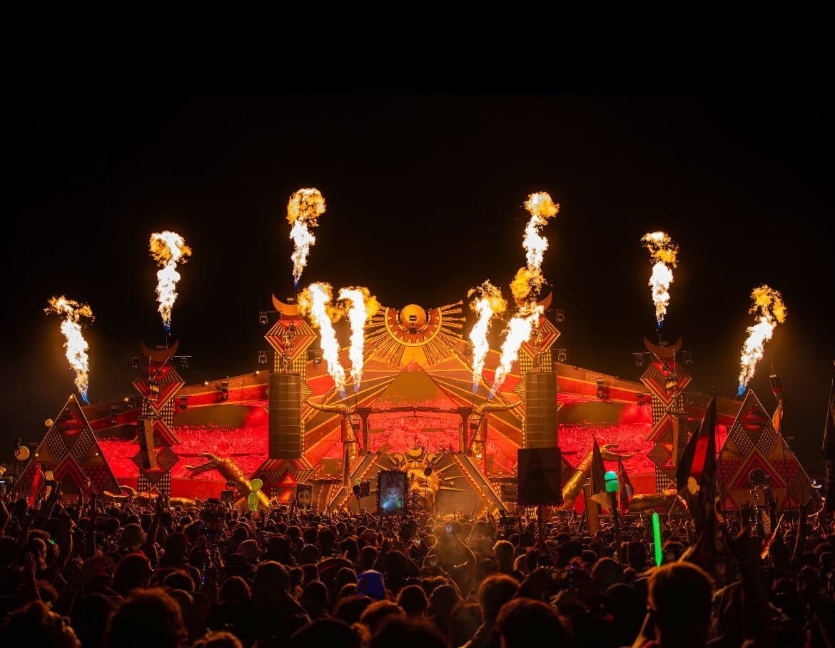 Colorful festival crowd dancing under neon lights