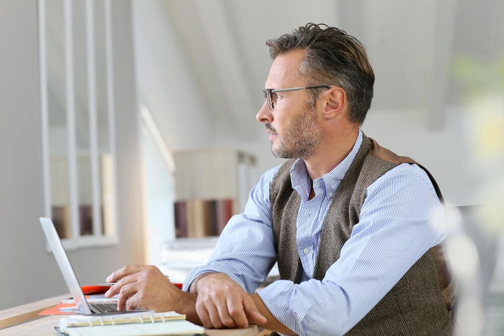Businessman at home looking away through window