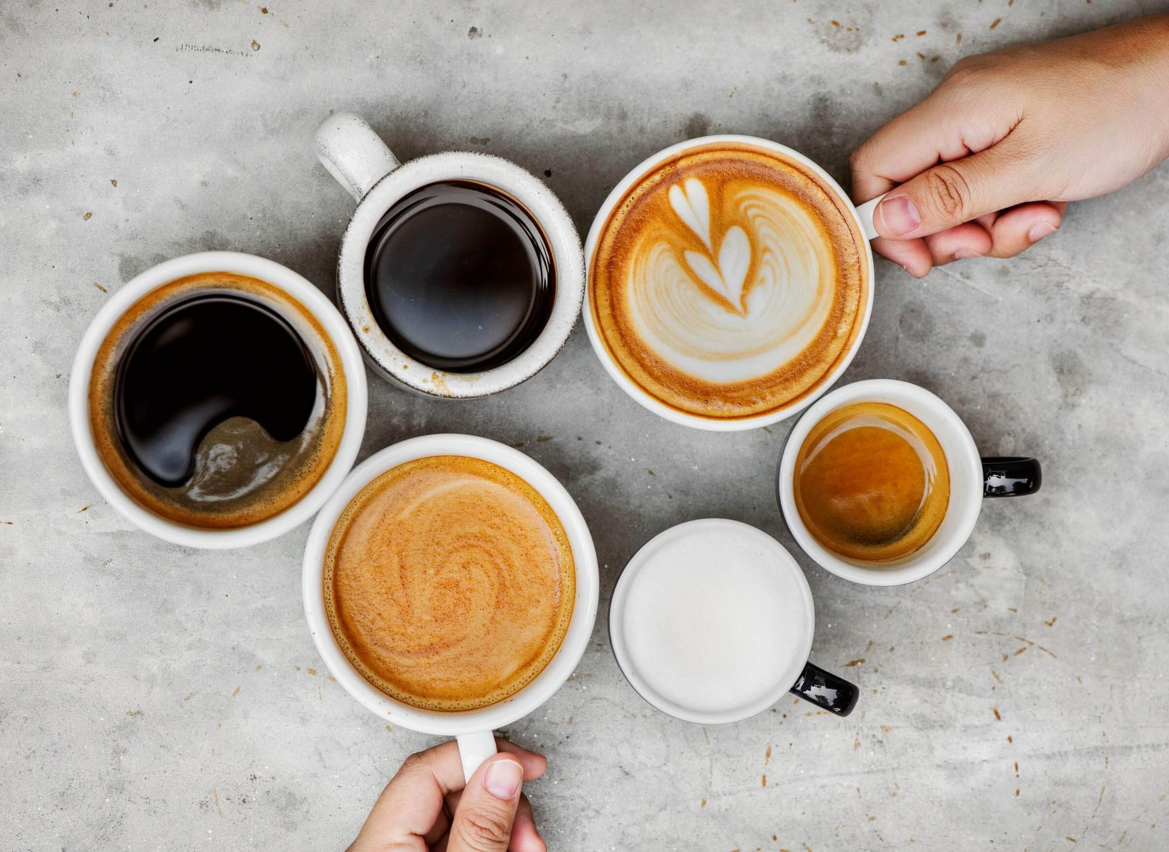 white coffee cup collection with black coffee and lattes
