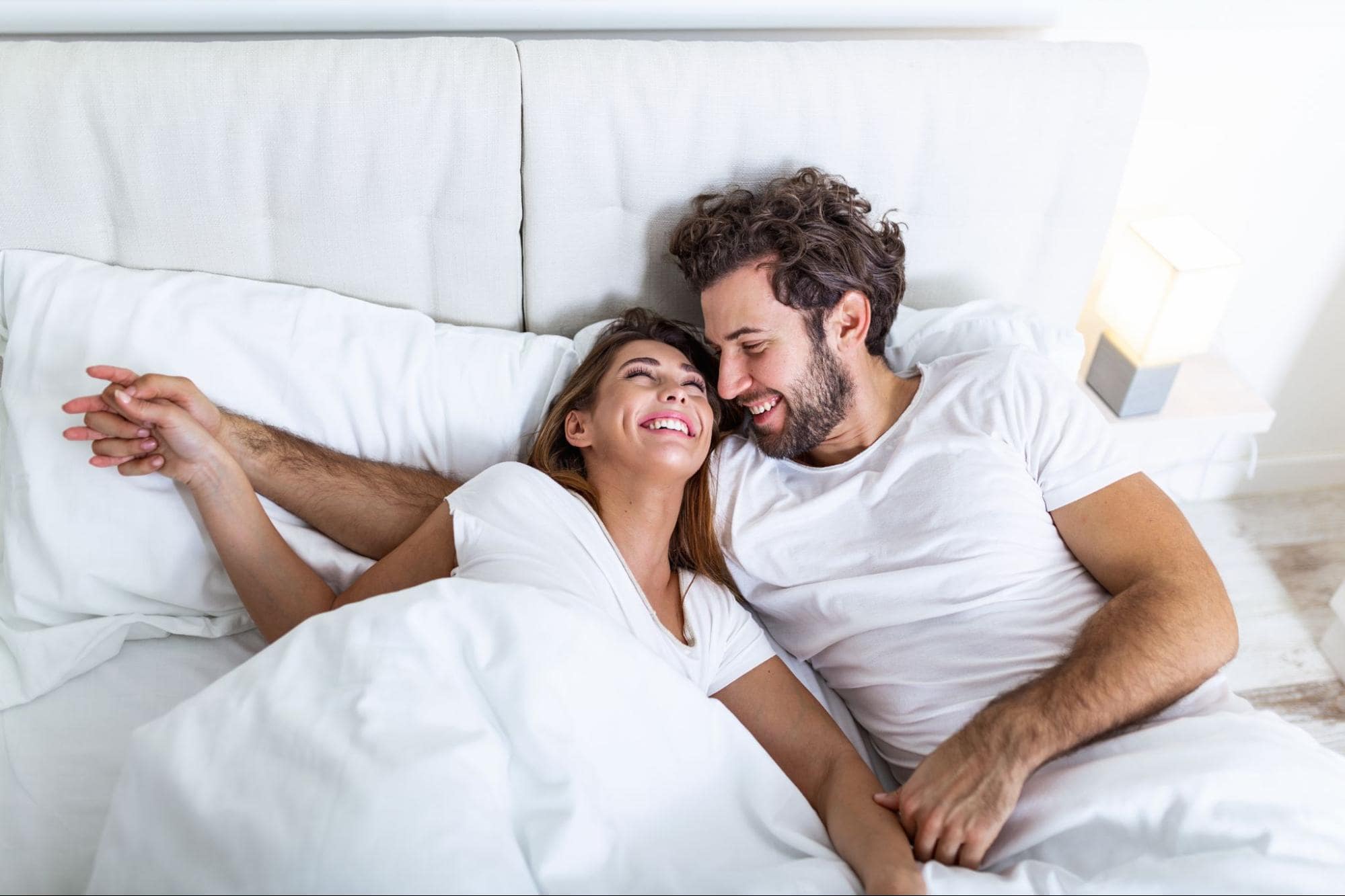 Man and Woman Holding Each Other in White SHEEX Cooling Sheets