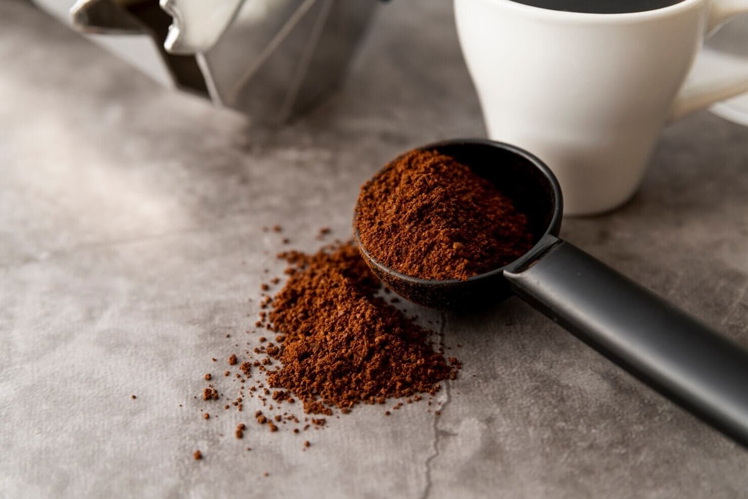 Portafilter overflowing with freshly ground coffee.