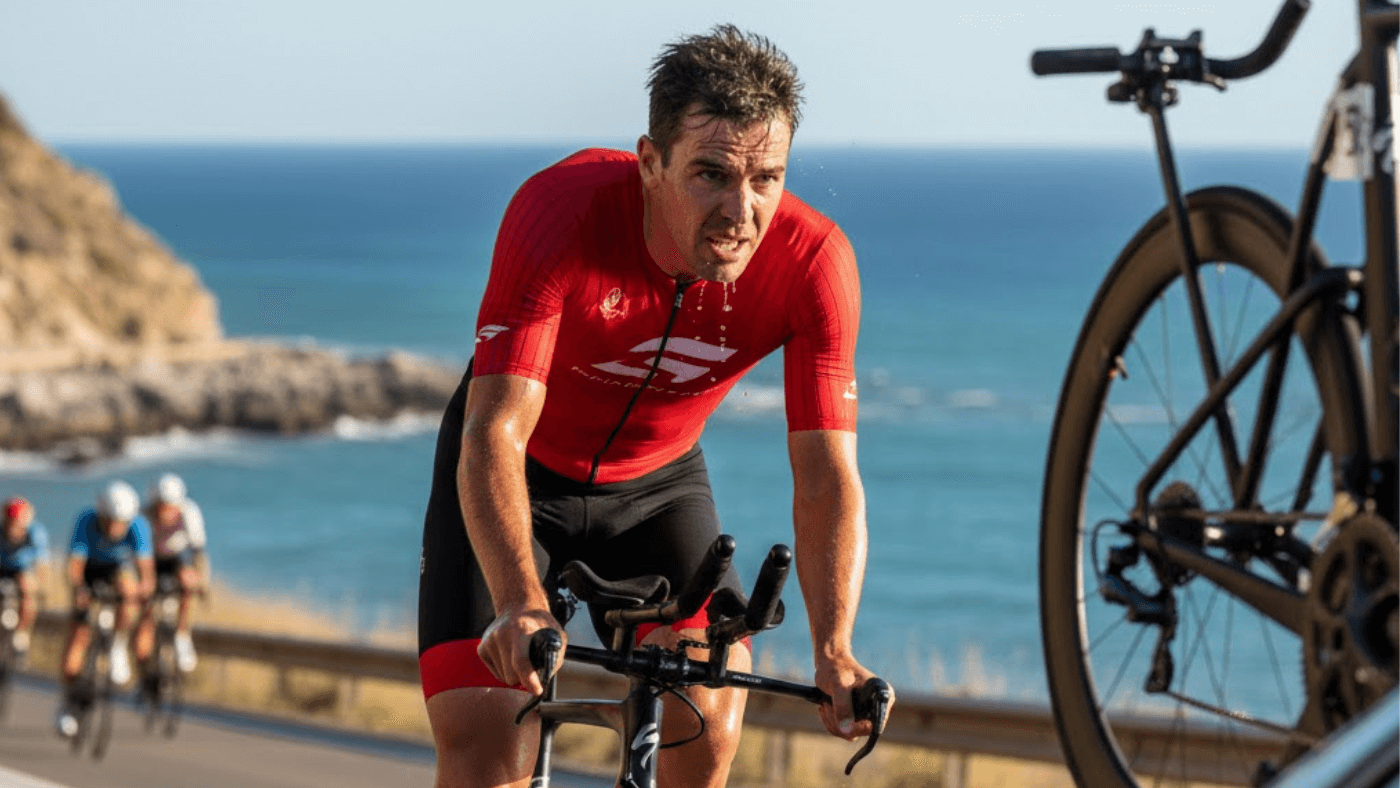 Triathlon caffeine strategy - triathlete using energy drops during Ironman bike leg