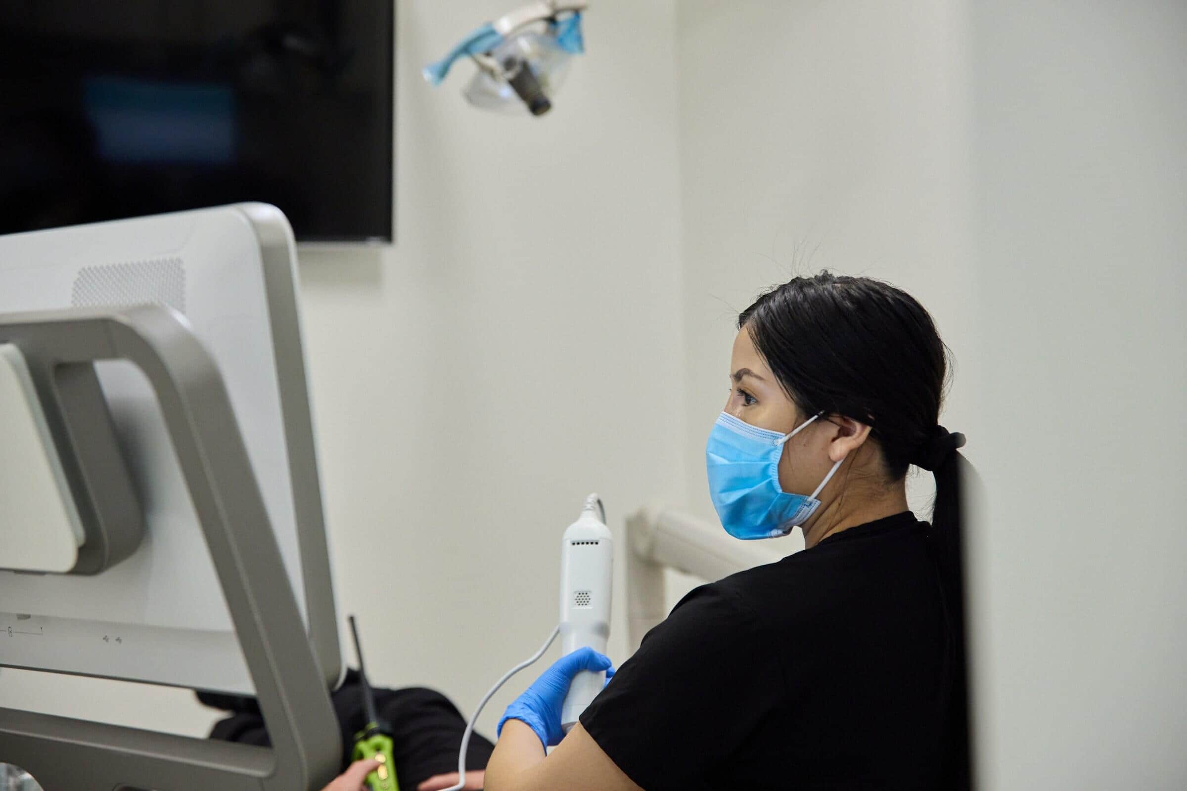 A woman wearing a face mask talking to a person