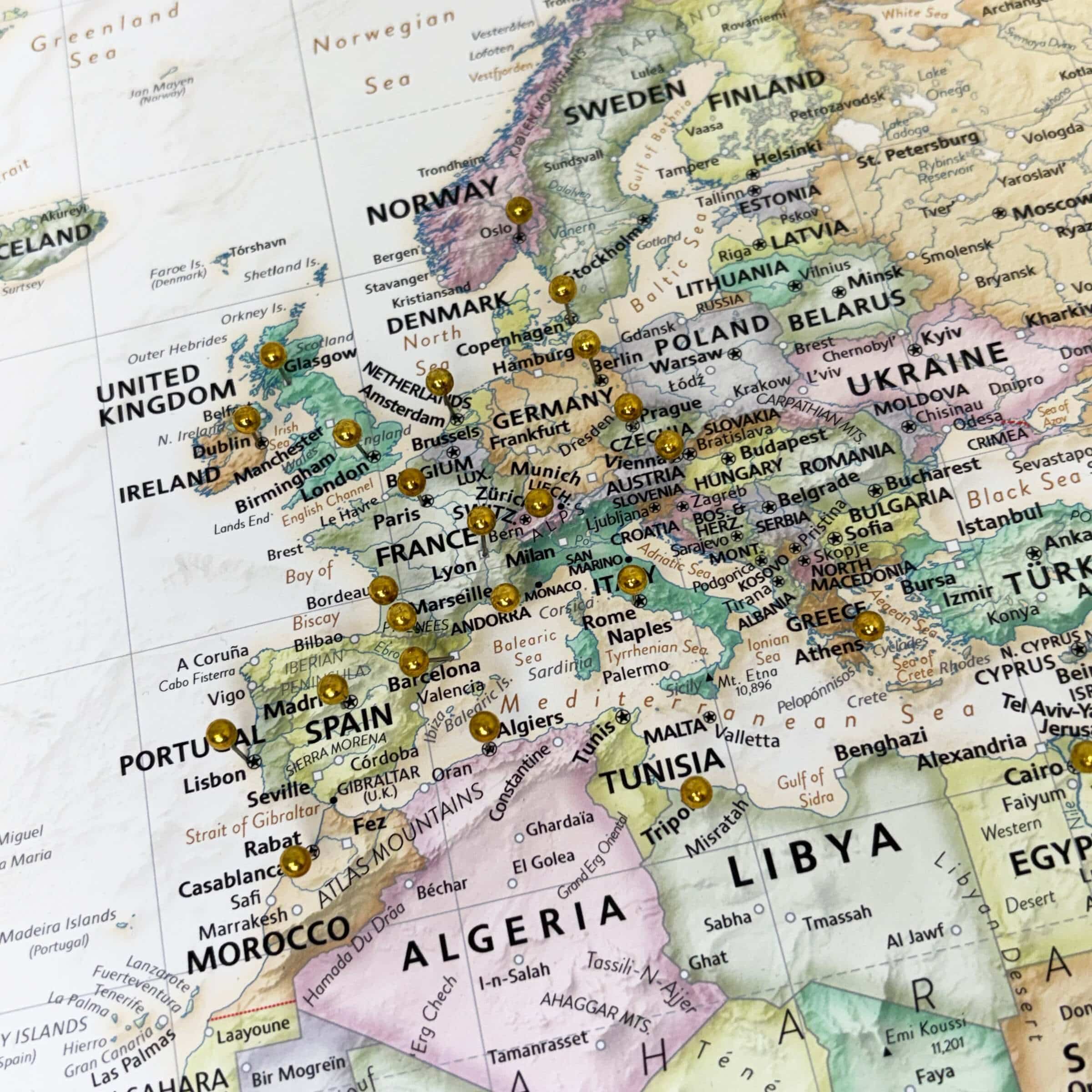 Push Pin World Map - Image focusing on Europe, with several metallic pins marking locations
