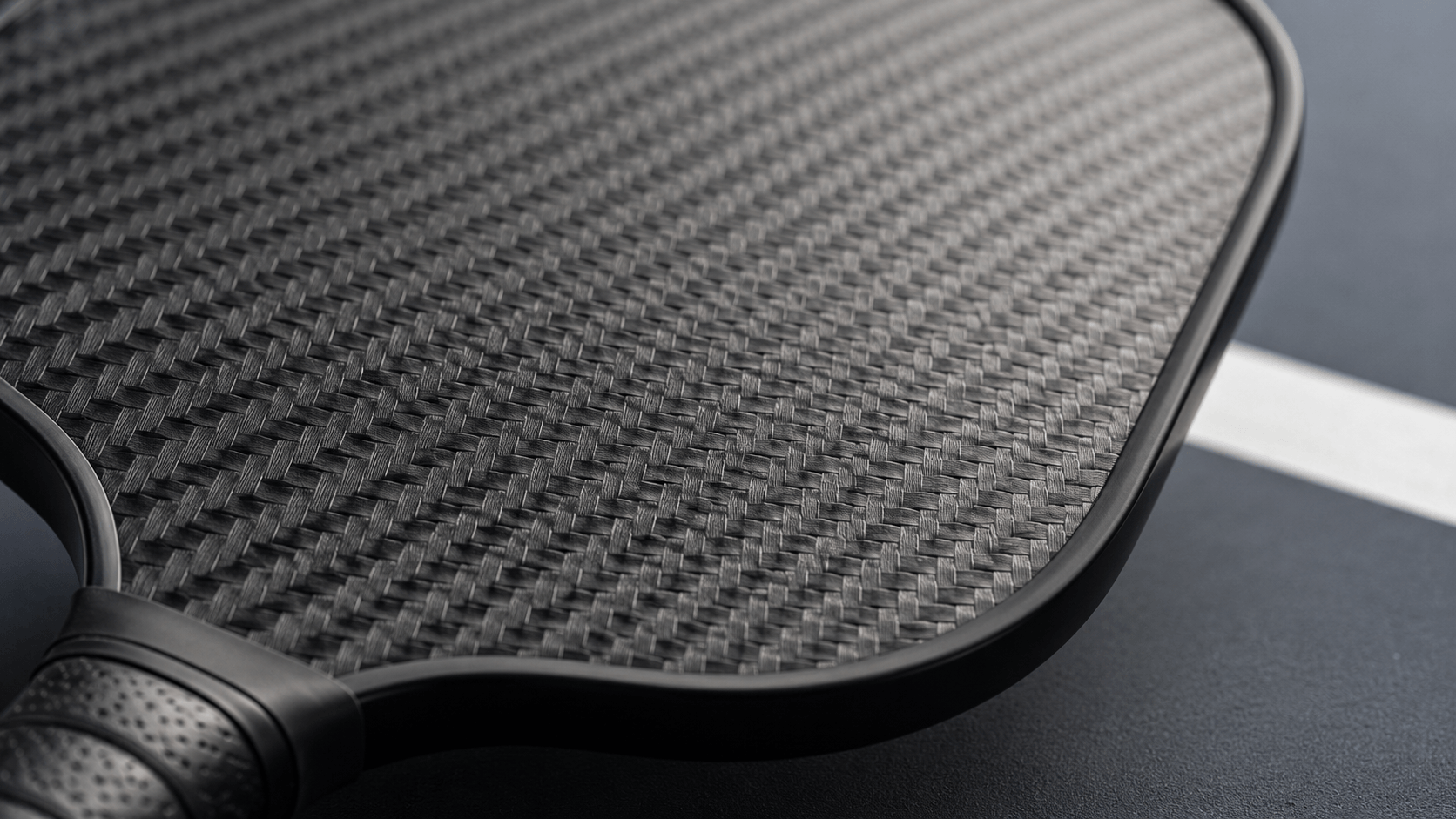 Pickleball paddle surface texture — carbon fiber paddle face close up