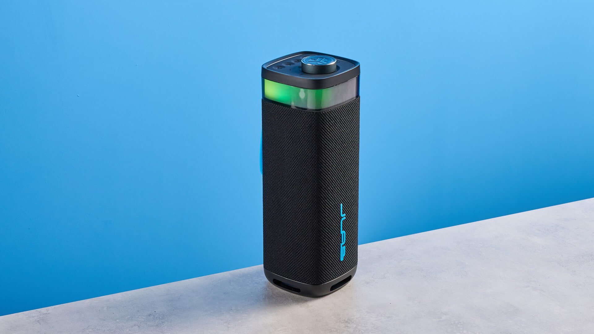 JLab JBuds Party speaker on a wooden surface