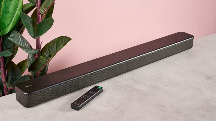 Sony HT-SF150 soundbar and remote on pink background.