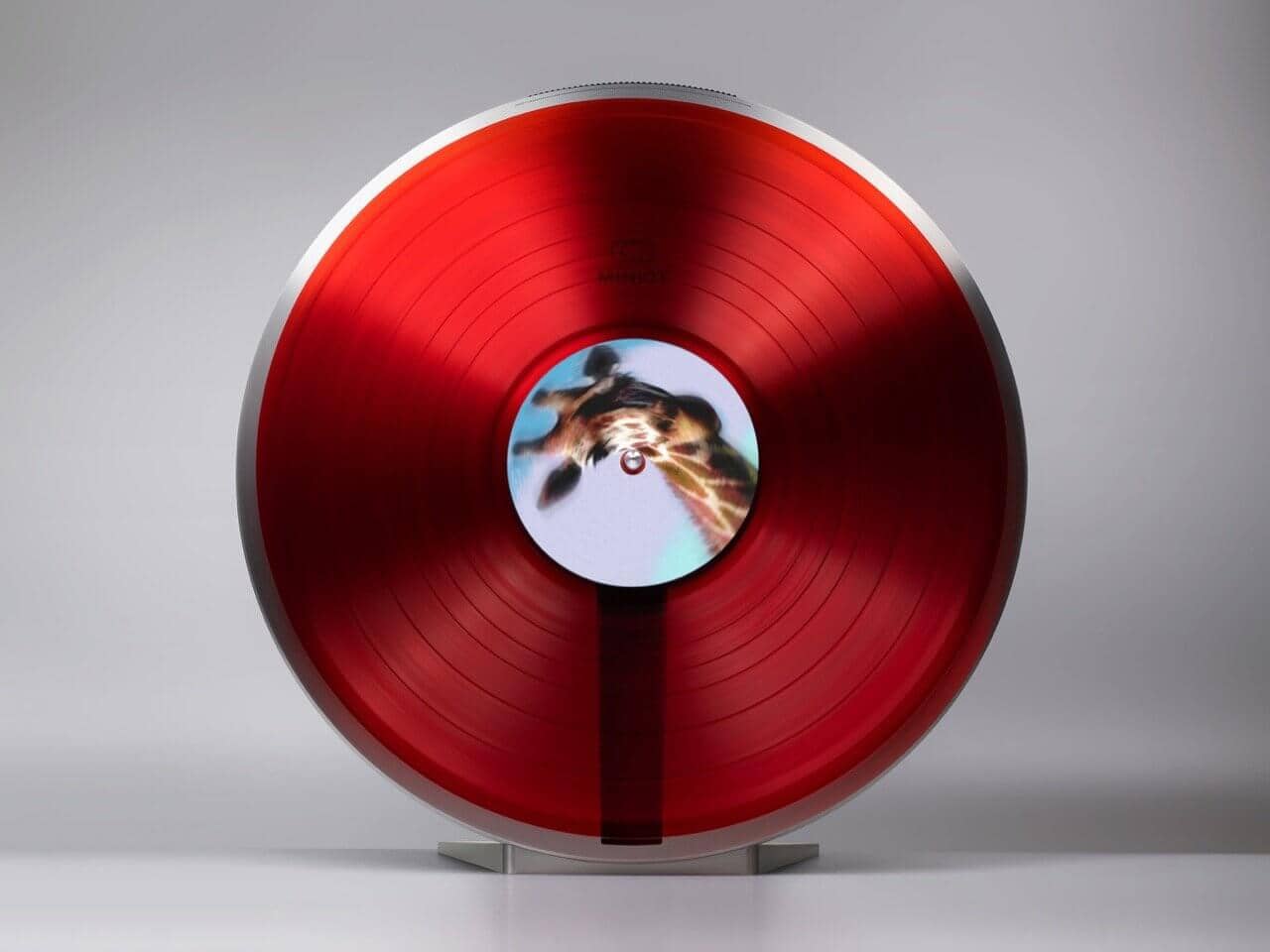 Miniot Wheel 3 vertical turntable showcasing a vinyl record spinning vertically against polished aluminum