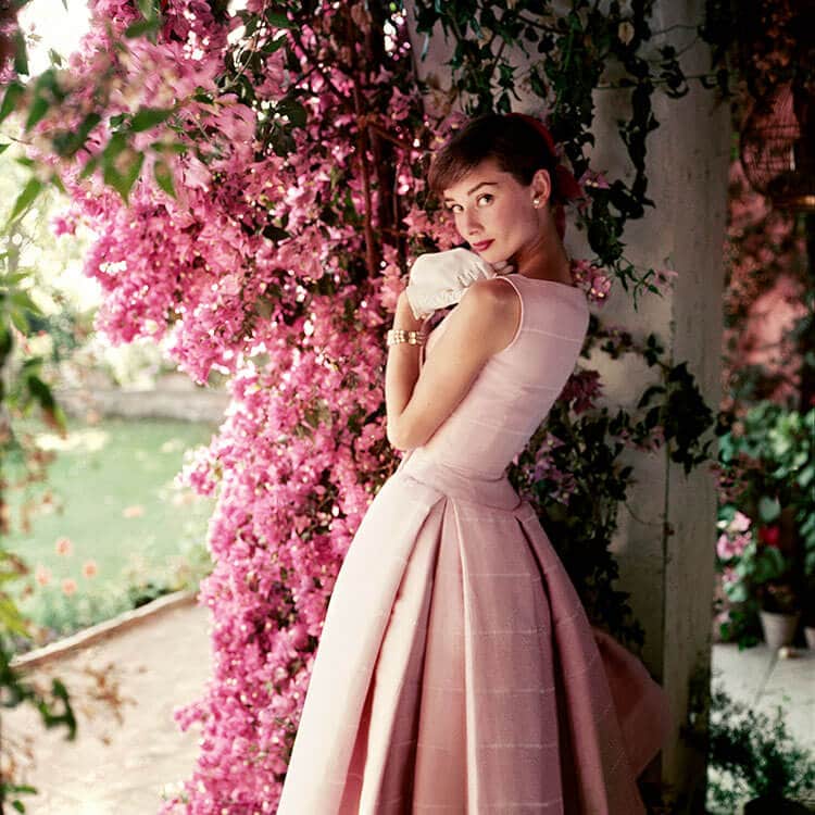 Audrey Hepburn models a Givenchy afternoon cocktail dress at Villa Rolli in 1955.