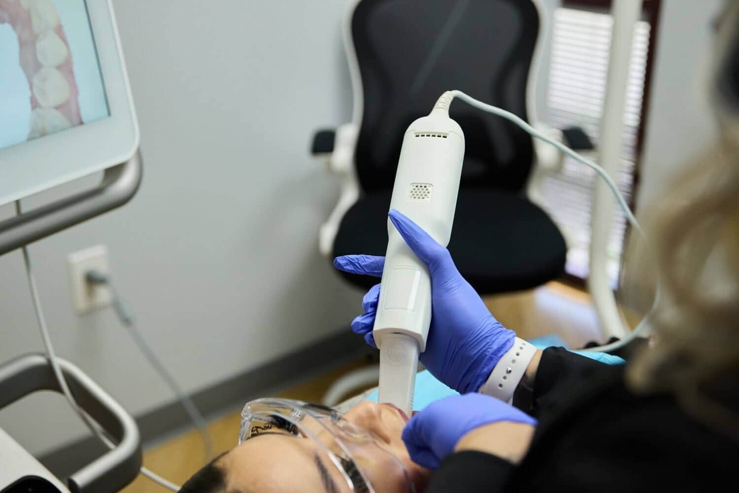 A person working on a patient's teeth