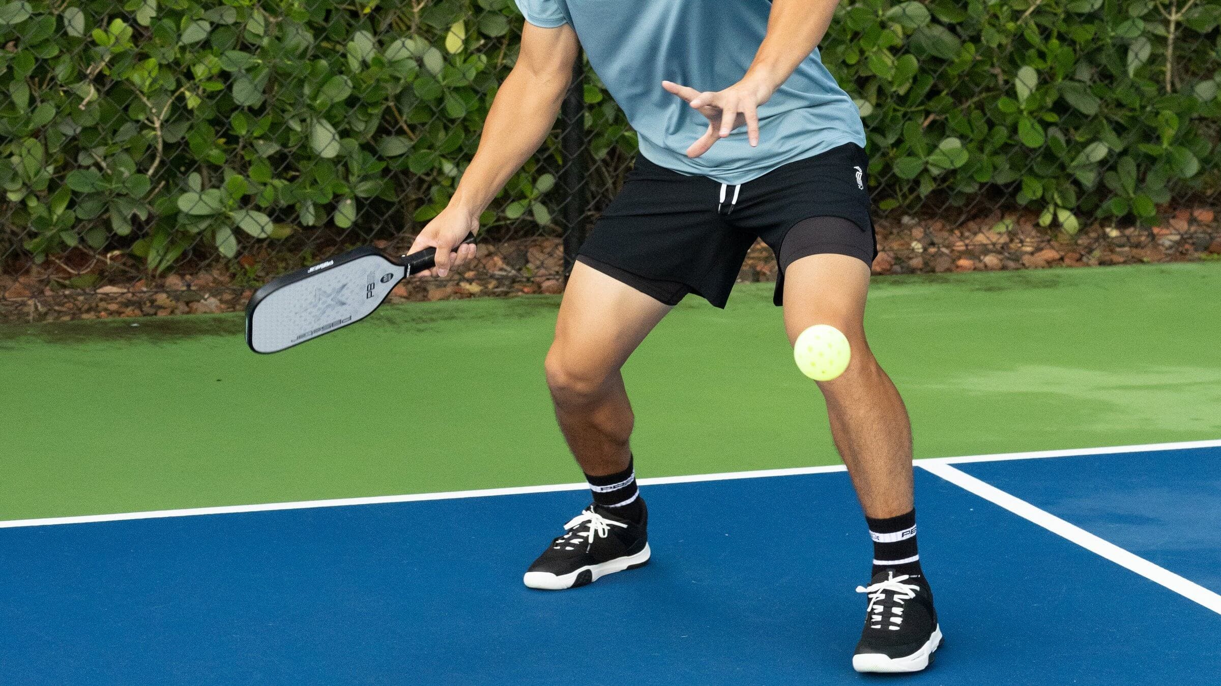 Man preparing to hit a pickleball shot