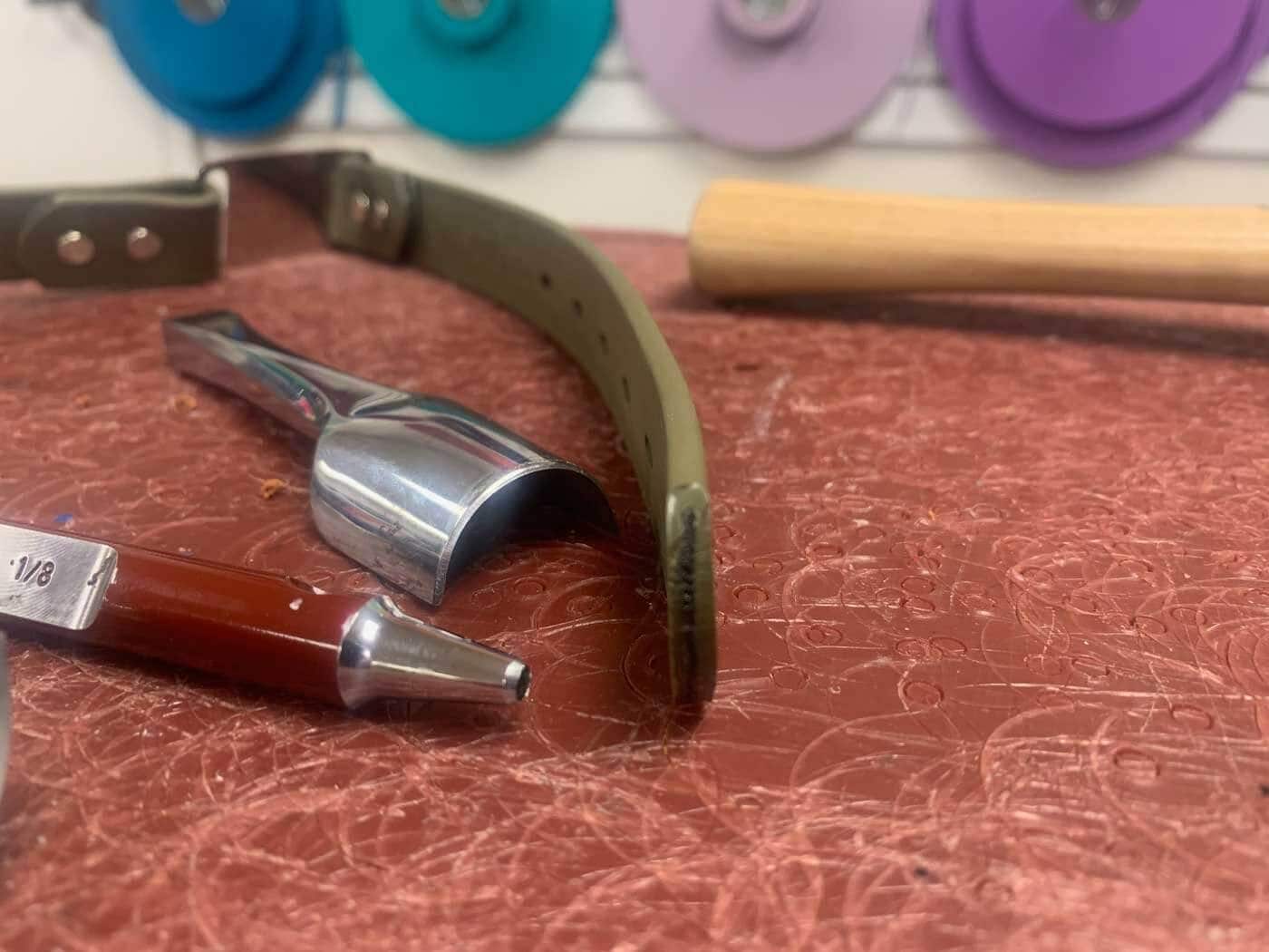 cross section of biothane beta waterproof Dog collar strap laying on cutting block in dogIDs workshop